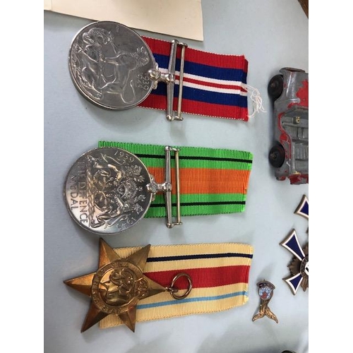 110 - Military interest, collection of military, and civil medals badges, photos and associated items