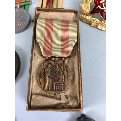 110 - Military interest, collection of military, and civil medals badges, photos and associated items