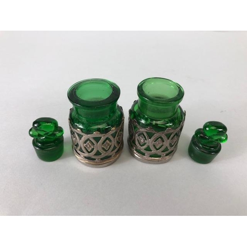 114 - Perfume bottles, pair of early 20th century green glass bottles with shamrock stoppers, in silver pl... 