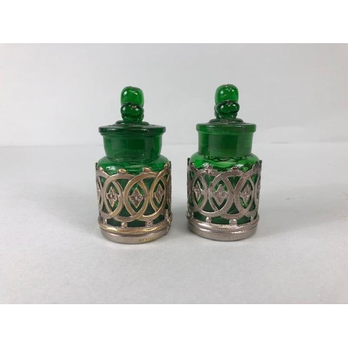 114 - Perfume bottles, pair of early 20th century green glass bottles with shamrock stoppers, in silver pl... 