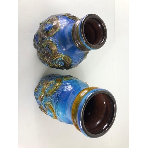 132 - Mid Century pottery, an associated pair of West German vases by, Carstems, decorated in high relief ... 