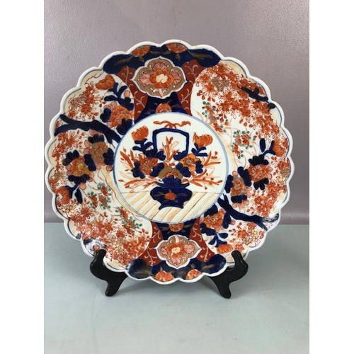 134 - Oriental ceramics, three Japanese Imari chargers one with scallop edge and flower designs approximat... 