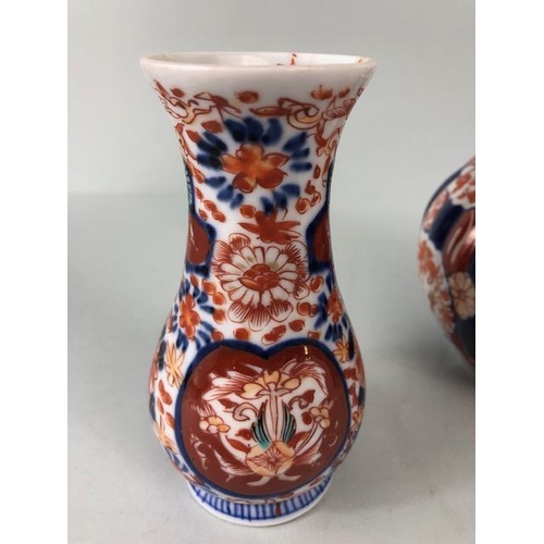 135 - Oriental ceramics, a pair of Japanese Imari vases decorated in blue and red with flowers, un-marked ... 