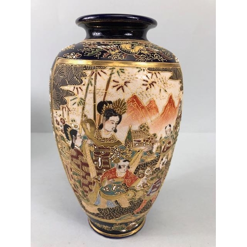 142 - Japanese pottery, a pair of Satsuma vases hand decorated with courtesans in gardens Cobalt blue with... 