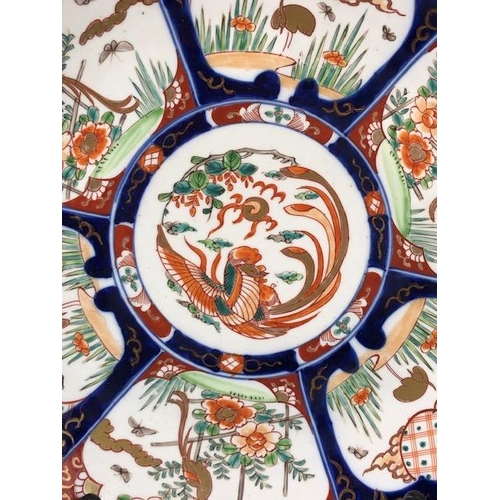 148 - Oriental ceramics, a larger Imari charger decorated with panels of birds and a phoenix to the centre... 