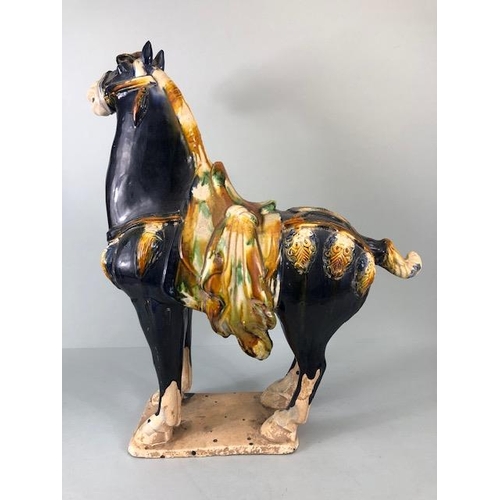 168 - Oriental Ceramics, Chinese Tang Horse of usual form decorated in dark blue glaze  with green and amb... 