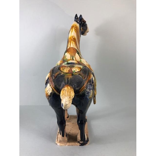 168 - Oriental Ceramics, Chinese Tang Horse of usual form decorated in dark blue glaze  with green and amb... 