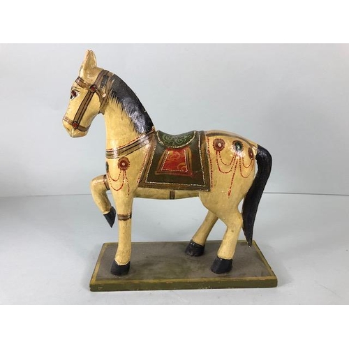 189 - Oriental carved and decorated wooden horse and two elephants, the largest approximately 24 cm high
