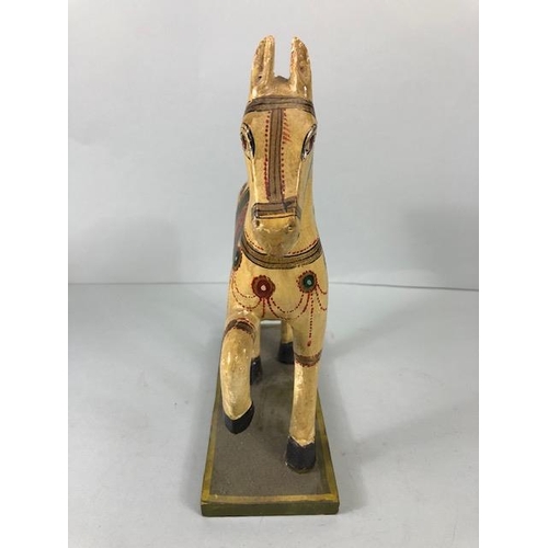 189 - Oriental carved and decorated wooden horse and two elephants, the largest approximately 24 cm high