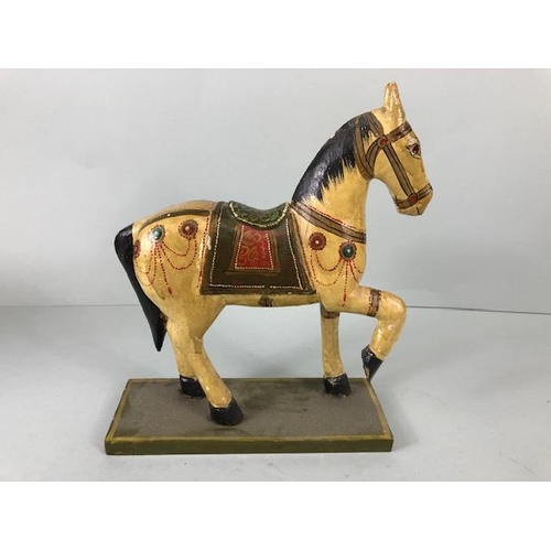 189 - Oriental carved and decorated wooden horse and two elephants, the largest approximately 24 cm high