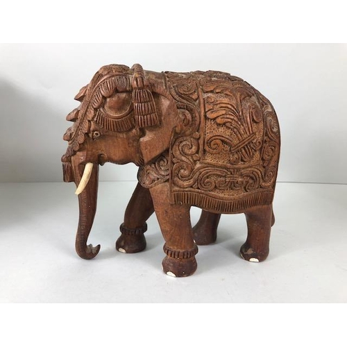 189 - Oriental carved and decorated wooden horse and two elephants, the largest approximately 24 cm high