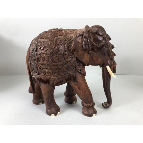 189 - Oriental carved and decorated wooden horse and two elephants, the largest approximately 24 cm high