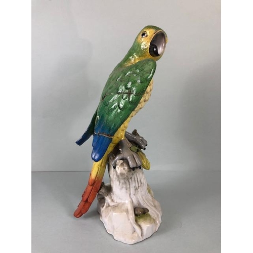 216 - 18th century style Majolica green parrot perched on a tree stump, old stapled repair to wing approxi... 