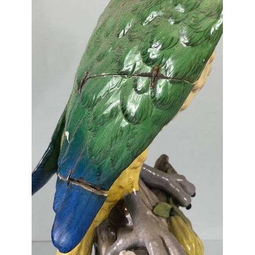 216 - 18th century style Majolica green parrot perched on a tree stump, old stapled repair to wing approxi... 