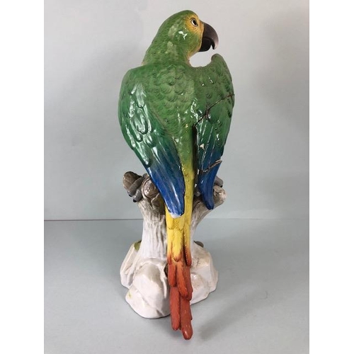 216 - 18th century style Majolica green parrot perched on a tree stump, old stapled repair to wing approxi... 