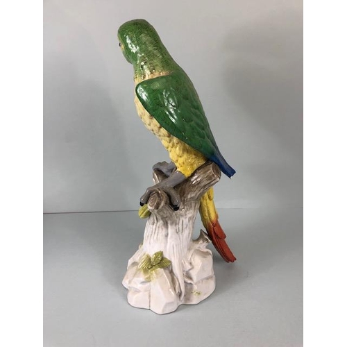 216 - 18th century style Majolica green parrot perched on a tree stump, old stapled repair to wing approxi... 