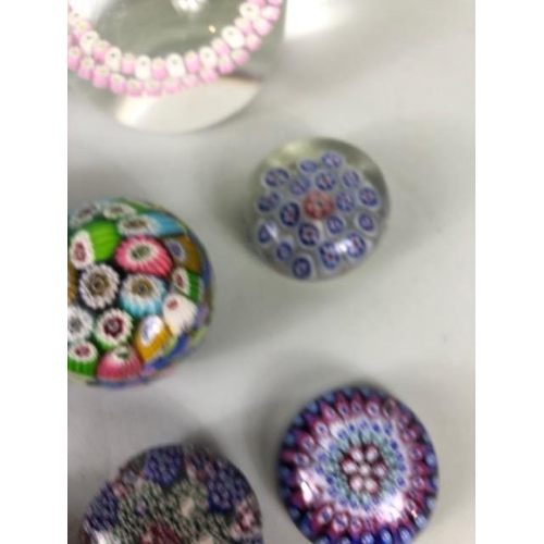 219 - Decorative Glass, a collection of Glass paperweights of Murano and Caithness designs ranging in size... 