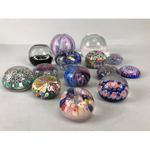 219 - Decorative Glass, a collection of Glass paperweights of Murano and Caithness designs ranging in size... 