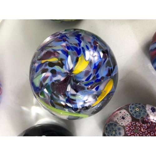 219 - Decorative Glass, a collection of Glass paperweights of Murano and Caithness designs ranging in size... 