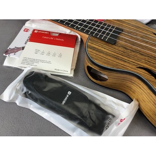 239 - Modern Ukulele, by Vango with carry case with bag of accessories , in card outer box