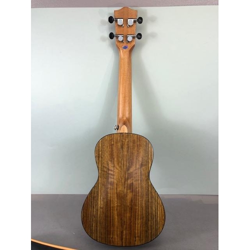 239 - Modern Ukulele, by Vango with carry case with bag of accessories , in card outer box