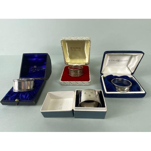 25 - Collection of four boxed Silver hallmarked various styles of napkin rings (total weight 109g)