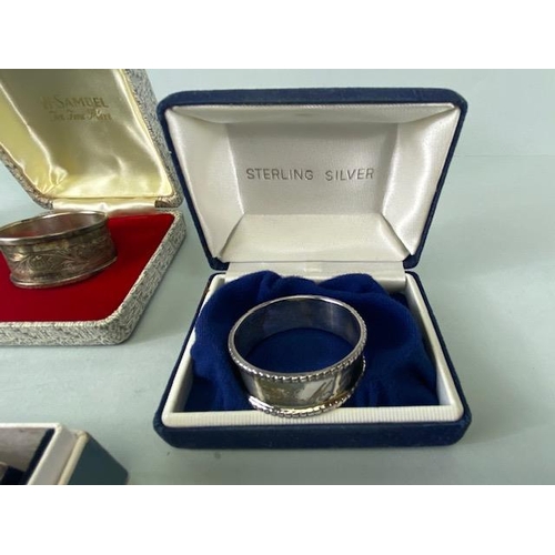 25 - Collection of four boxed Silver hallmarked various styles of napkin rings (total weight 109g)