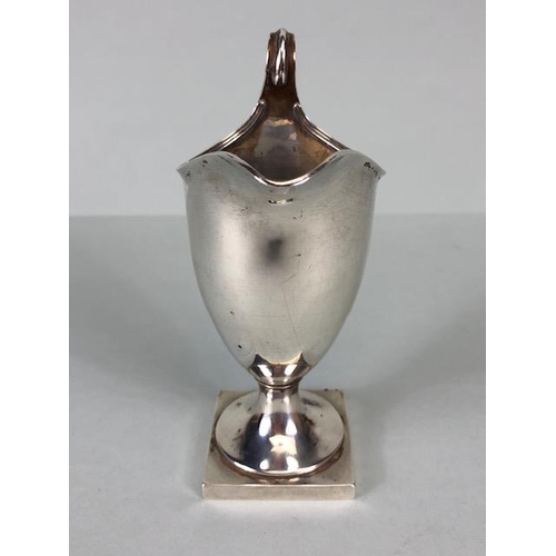 42 - Silver Hallmarked jug on square base looping handle and fluted spout and rim, hallmarked for Chester... 