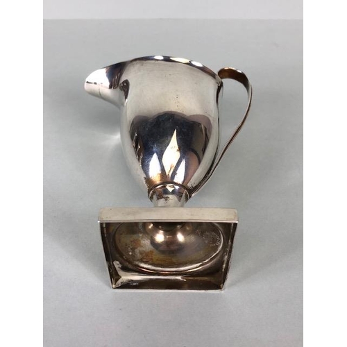 42 - Silver Hallmarked jug on square base looping handle and fluted spout and rim, hallmarked for Chester... 