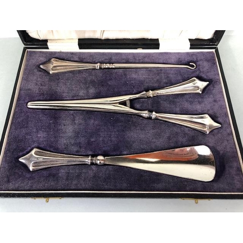 48 - Silver handled set of Button pull, glove stretcher and shoe horn in presentation case