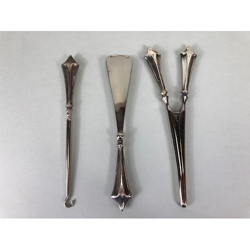 48 - Silver handled set of Button pull, glove stretcher and shoe horn in presentation case