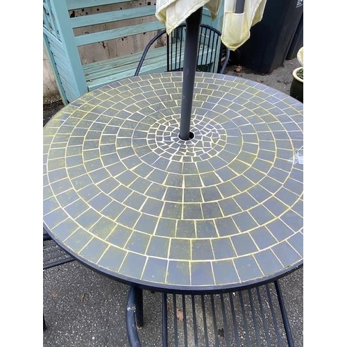 506 - Circular garden tile top table, four chairs and a parasol