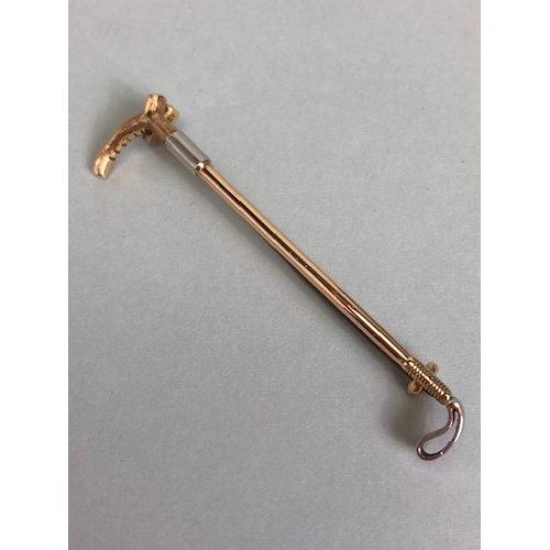 65 - 15ct Gold brooch in the form of a Horse riding Crop approx 60mm in length and total weight approx 5.... 