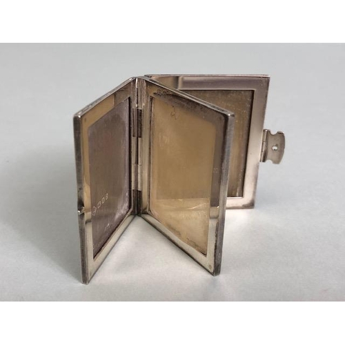 69 - Silver Hallmarked miniature photo frame in the form of a book with clasp opening to reveal four phot... 