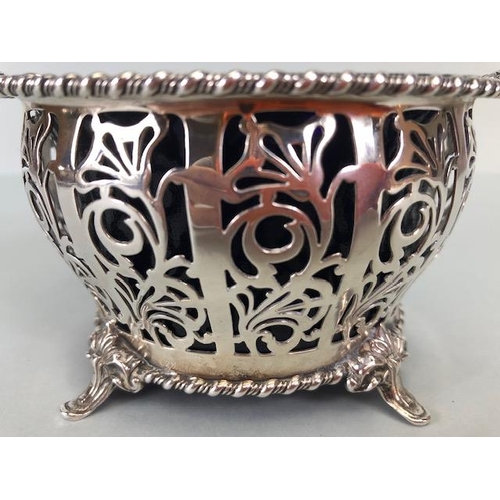 7 - Silver hallmarked open work or pierced design basket with twin handles on four splayed feet containi... 