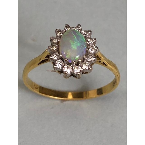 71 - 18ct Gold ring set with an oval Opal and surrounded by diamonds 'P'