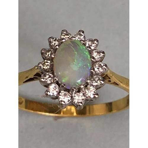 71 - 18ct Gold ring set with an oval Opal and surrounded by diamonds 'P'