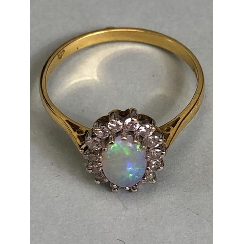 71 - 18ct Gold ring set with an oval Opal and surrounded by diamonds 'P'