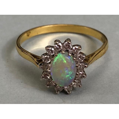 71 - 18ct Gold ring set with an oval Opal and surrounded by diamonds 'P'