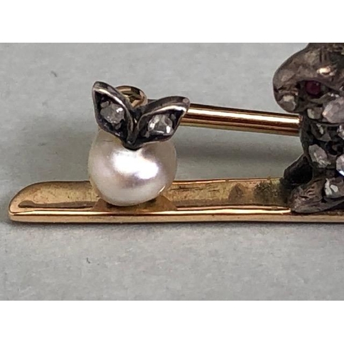 77 - Yellow metal bar brooch mounted with a white metal diamond set rabbit staring at a pearl apple appro... 