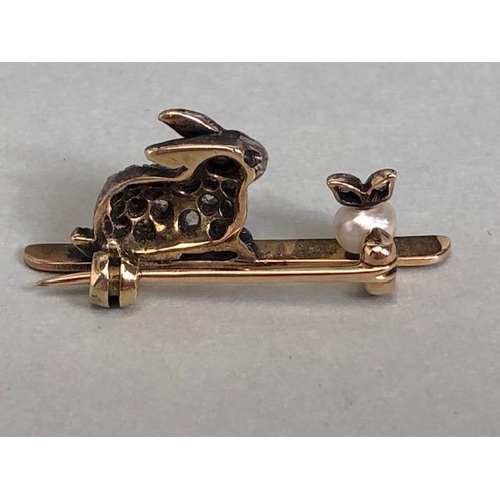 77 - Yellow metal bar brooch mounted with a white metal diamond set rabbit staring at a pearl apple appro... 