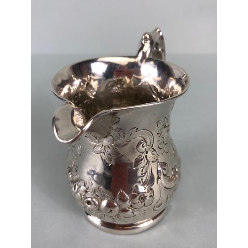 8 - Victorian Silver Hallmarked Cream Jug Birmingham 1877, decorated with repousse flora and foliage and... 