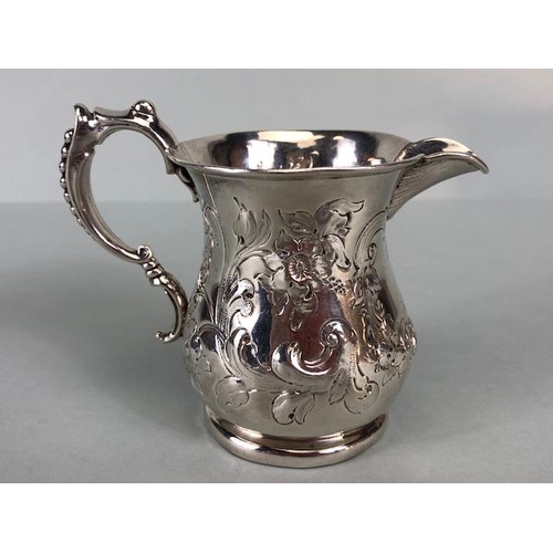 8 - Victorian Silver Hallmarked Cream Jug Birmingham 1877, decorated with repousse flora and foliage and... 