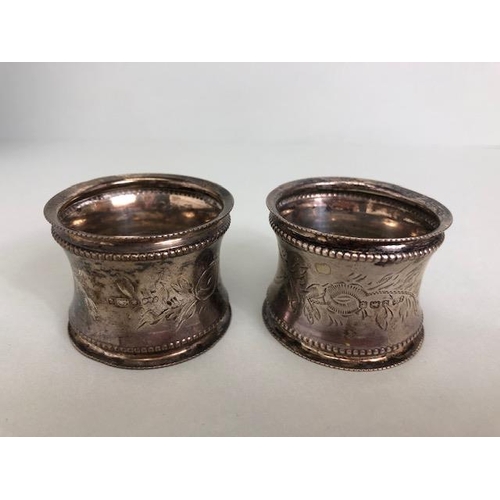 96 - English hallmarked silver, two matching napkin rings with beaded edges and flower decoration and a b... 