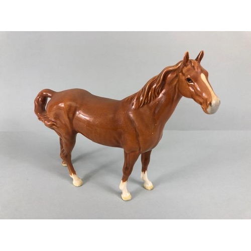 104 - Beswick, Arabic horse with swish back tail marked Beswick to underside and a foal, with unreadable m... 