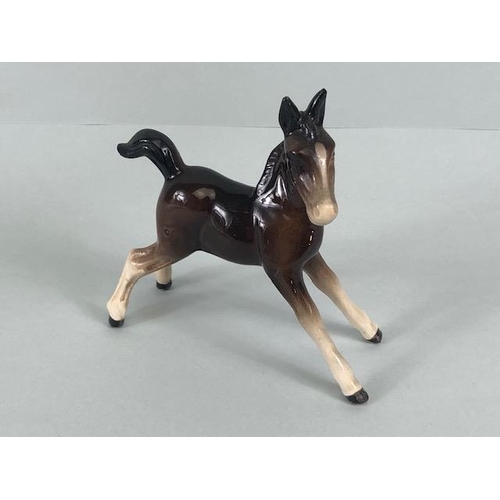 104 - Beswick, Arabic horse with swish back tail marked Beswick to underside and a foal, with unreadable m... 