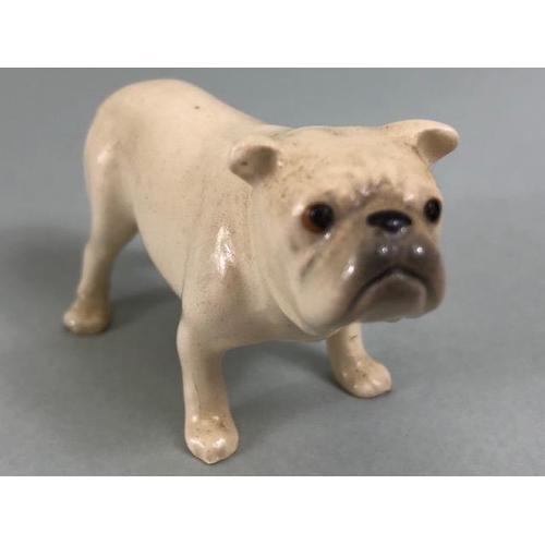 127 - Ceramic Bulldogs, four bulldog figures of varying size, one with Coppercraft trade label to base, on... 