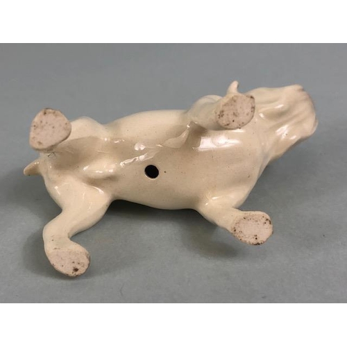 127 - Ceramic Bulldogs, four bulldog figures of varying size, one with Coppercraft trade label to base, on... 