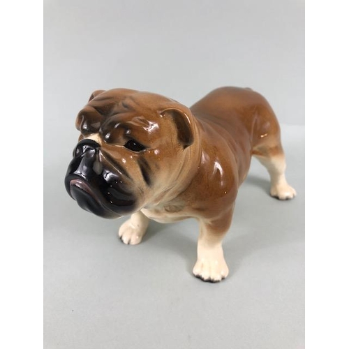 127 - Ceramic Bulldogs, four bulldog figures of varying size, one with Coppercraft trade label to base, on... 