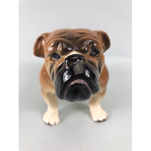 127 - Ceramic Bulldogs, four bulldog figures of varying size, one with Coppercraft trade label to base, on... 